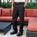 A man wearing Uncommon Chef black pants.