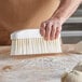 a close-up of a broom sweeping a surface