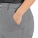 A person wearing Uncommon Chef houndstooth chef pants with their hand in a pocket.