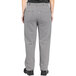 A person wearing Uncommon Chef black and white houndstooth chef pants.