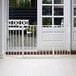 A white L.A. Baby safety gate with a white door.