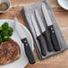 A plate of steak and broccoli with a Choice steak knife on the side.