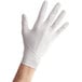 a hand wearing a white glove