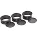 Three round metal Wilton mini springform cake pans with black non-stick coating.