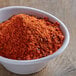 A bowl of Cattlemen's Chili Lime BBQ Rub, a red powder.