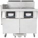 A Frymaster natural gas floor fryer with two frypots and automatic filtration.