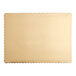 A close up of a gold laminated rectangular paper cake pad with scalloped edges.