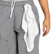 A person wearing Uncommon Chef houndstooth cargo pants with a towel in the pocket.