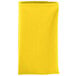 A folded yellow Intedge cloth napkin.