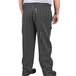 A person wearing Uncommon Cargo black and white pinstripe chef pants.
