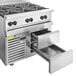 A stainless steel Wolf commercial gas range with a refrigerated drawer.