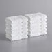 A stack of white Lavex Premium washcloths.