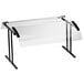 a clear glass table with black legs