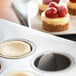 A Fox Run mini cheesecake pan with mini cheesecakes topped with raspberries.