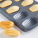 A Fox Run Madeleine sheet pan with 12 madeleines.