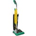 A Bissell Commercial ProShake bagged upright vacuum cleaner with a green and black handle.