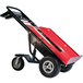 A red and black Magliner hand truck with a cylinder or inflatable attachment.