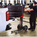 A man using a Magliner LiftPlus to move tires on a truck.