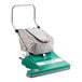 A green and grey Bissell Commercial wide area vacuum cleaner with a white bag.