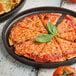 A slice of cheese pizza on a Tablecraft brown melamine platter.
