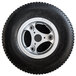 A black Magliner foam filled drive tire with a silver rim.