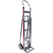 A silver hand truck with wheels and red stripes.