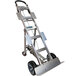 A silver Magliner appliance hand truck with black wheels and a handle.