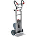 A Magliner heavy-duty powered stair climbing hand truck with a folding red handle.