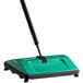 a green and black broom
