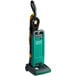 A green and black Bissell Commercial upright vacuum cleaner.