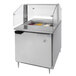 A Beverage-Air refrigerated sandwich prep table with a sneeze guard over food containers on a counter.