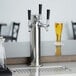 A silver Assure 190TRIPTOWER beer tap on a counter.