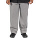 A person wearing Uncommon Chef Houndstooth checkered pants.