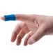 A close-up of a person's finger with a blue Medique adhesive strip bandage.