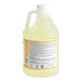 A jug of yellow Noble Chemical Low Temp Sanitizer with a white label and handle.