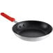 A Choice aluminum non-stick frying pan with a red silicone handle.