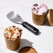 An OXO aluminum ice cream spade scooping ice cream into a cup.