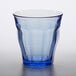 A Duralex Picardie marine blue glass tumbler on a table.