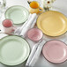 A table set with Luzerne Tin Tin green porcelain plates and cups.