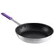 A close-up of a Choice aluminum non-stick fry pan with a purple silicone handle.