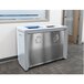 A rectangular metal Coliseum two-stream recycling receptacle in hammered grey with a recycle symbol.