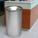 A stainless steel Ex-Cell Kaiser Premier Series waste receptacle next to a counter.