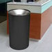 A black Ex-Cell Kaiser Premier Series steel round waste receptacle.