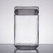 a clear glass container with a black lid