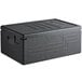 A black plastic Cambro Cam GoBox top loading food pan carrier with lid.