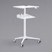 A white Safco adjustable height stand-up workstation with wheels.