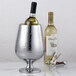 A wine bottle in a hammered stainless steel wine cooler.