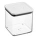 An OXO Good Grips clear square plastic food storage container with a white lid.