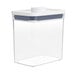 An OXO clear plastic food storage container with a white lid.