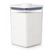 A clear plastic OXO Good Grips food storage container with a white lid.